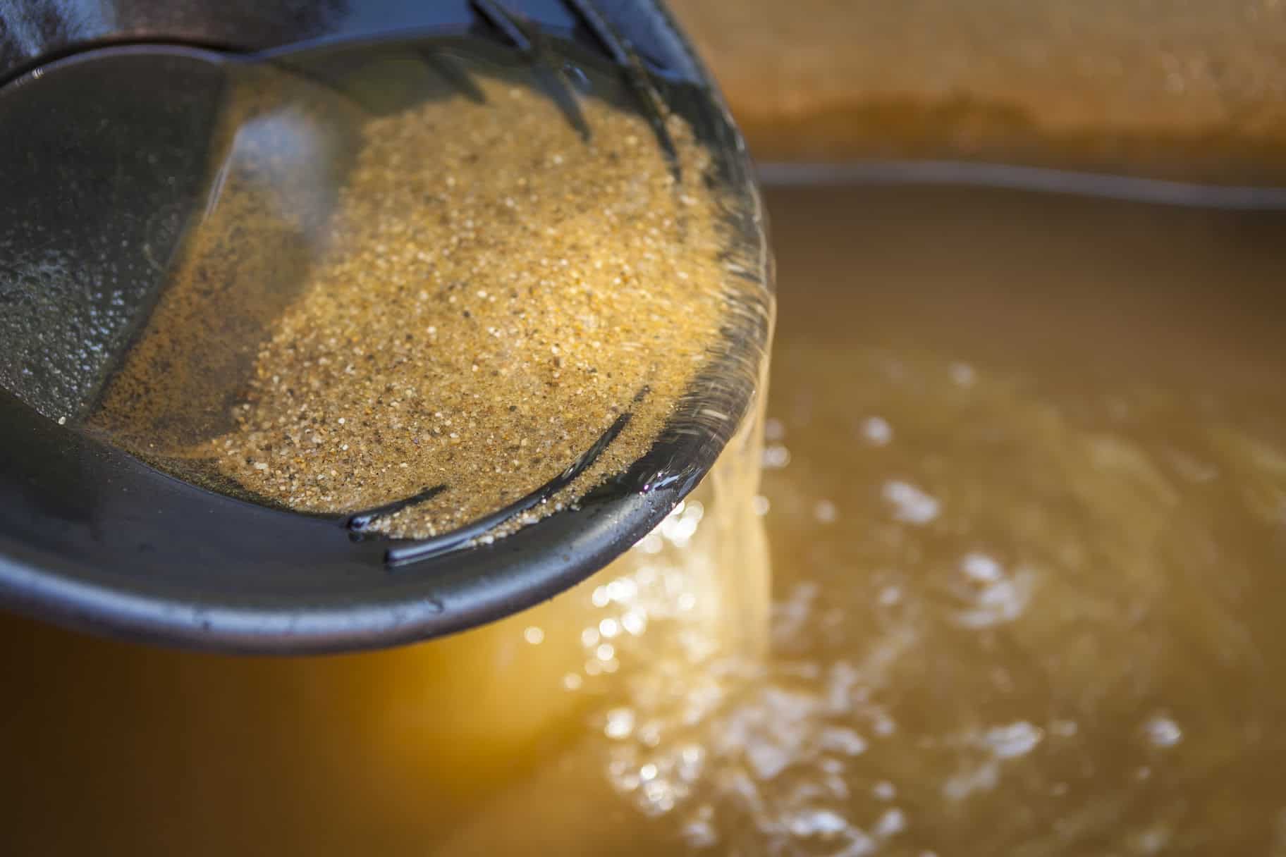 Gold-bearing sand in a pan