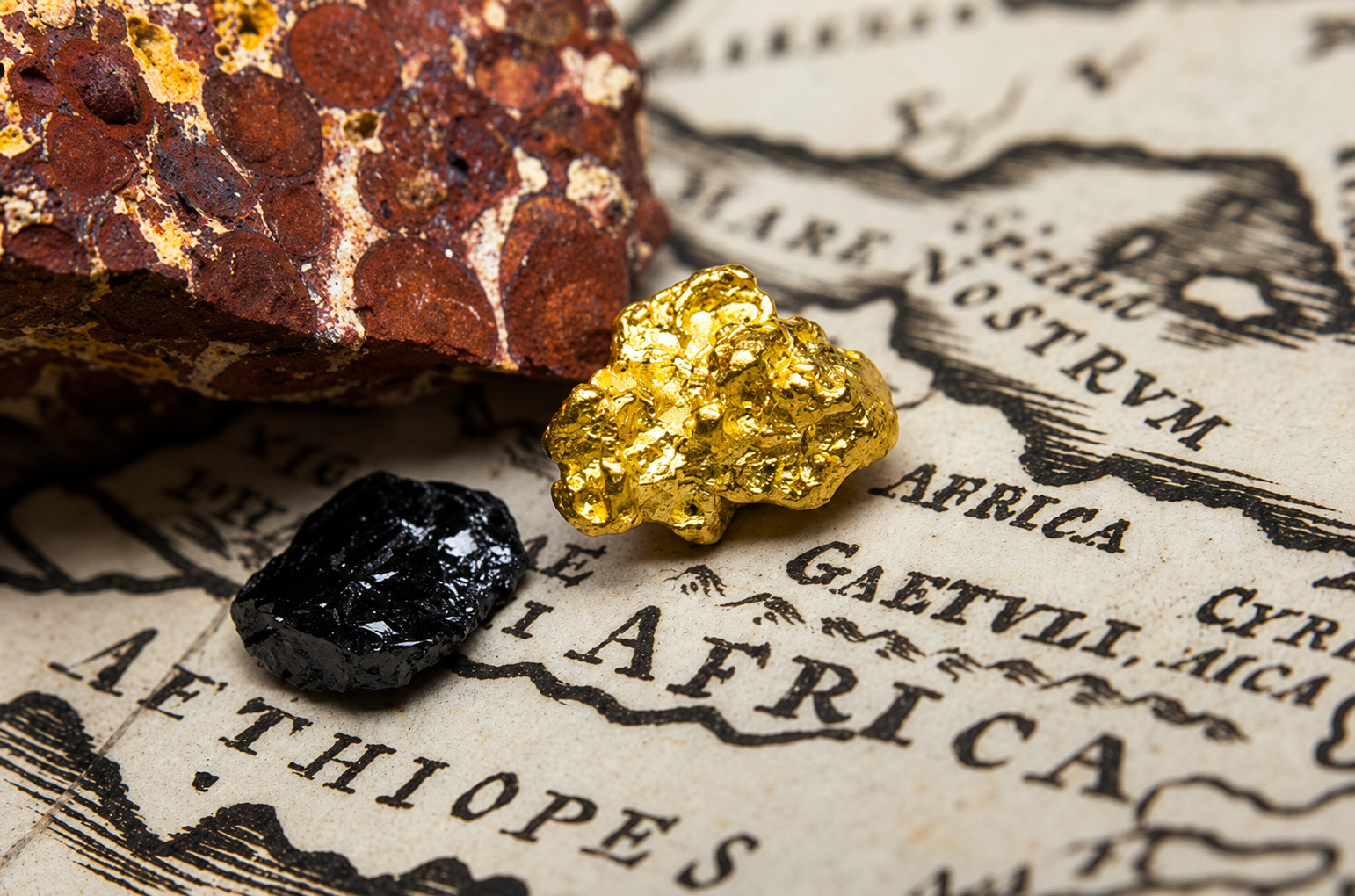 Gold and mineral rock on a map of Africa